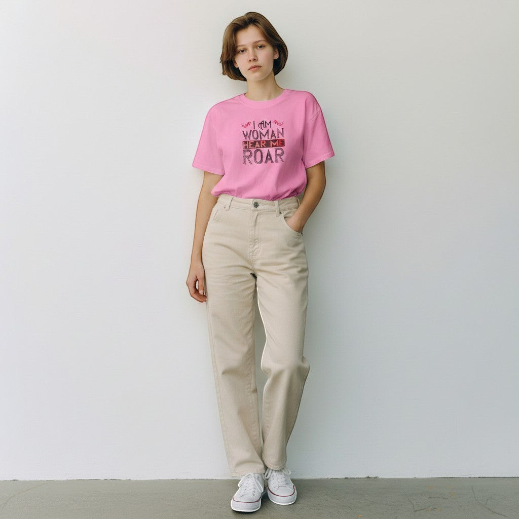 Purple Expressions pink cotton tee with "I Am Woman Hear Me Roar" graphic print. Model wears a crew neck short sleeve shirt.