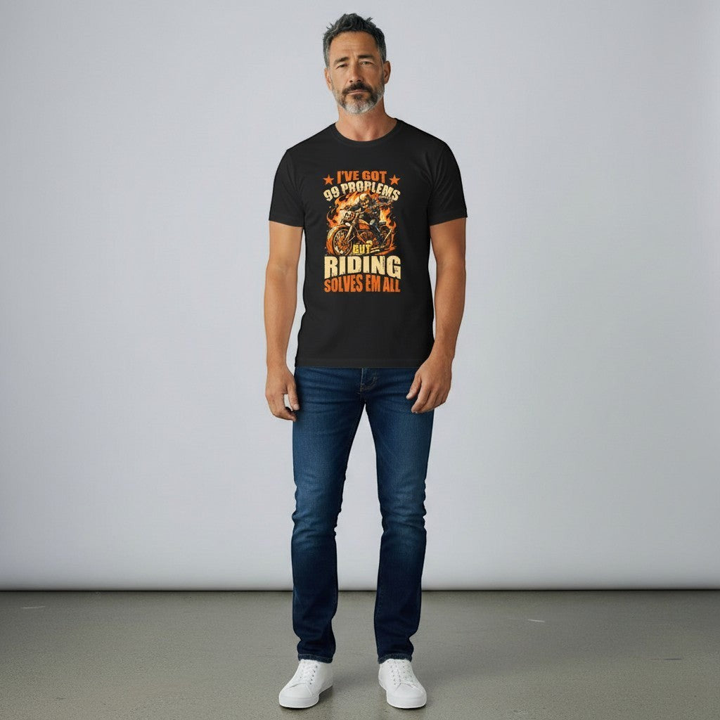 Purple Expressions black cotton t-shirt with a graphic of a skeleton riding a motorcycle with flames and the text "I'VE GOT 99 PROBLEMS BUT RIDING SOLVES EM ALL".