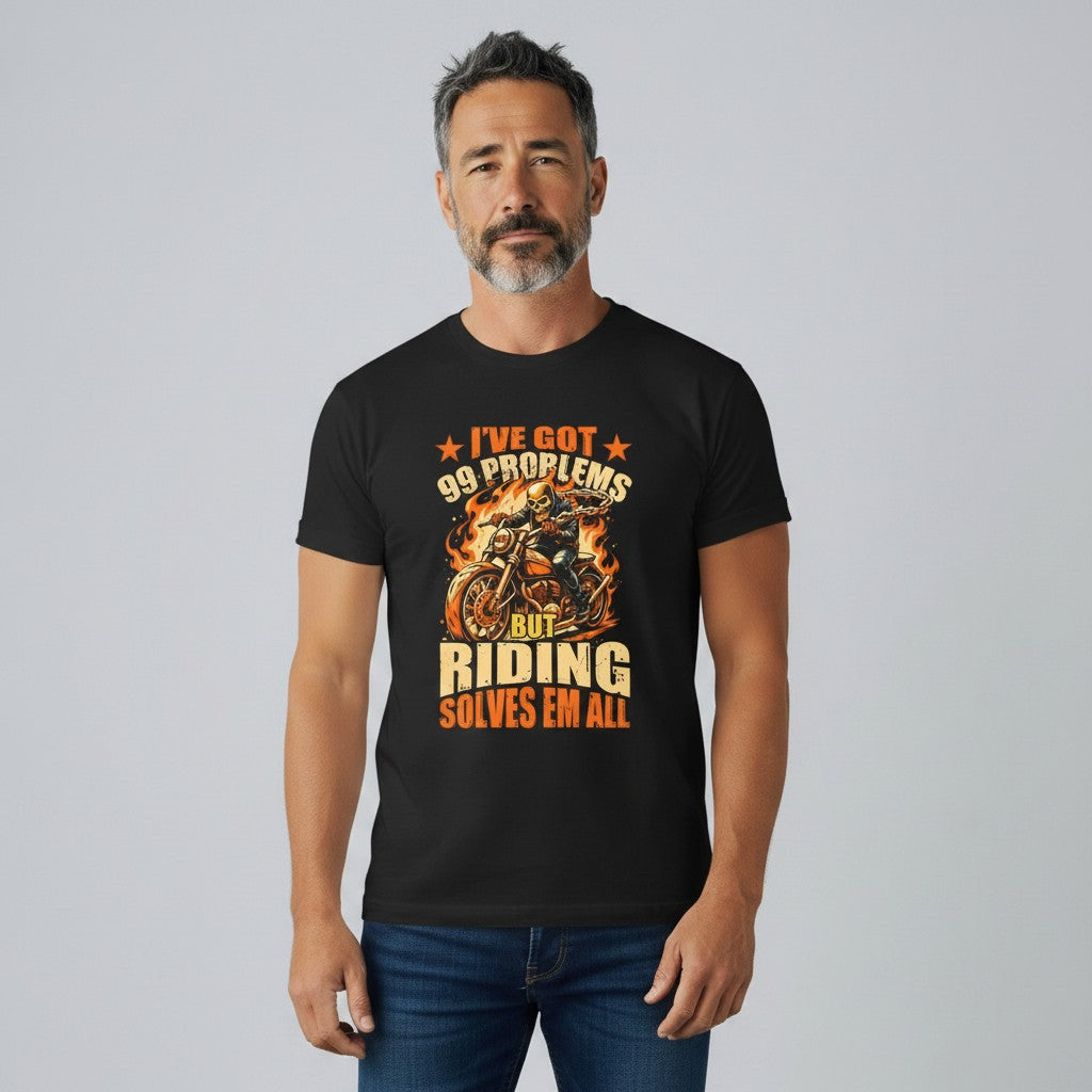 Purple Expressions black 100% cotton biker tee with '99 Problems But Riding Solves Em All' graphic. Features a skeleton rider on a motorcycle with flames.
